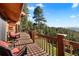 Spacious deck with stunning views of the lush forest and distant mountains, perfect for outdoor relaxation at 4560 Hilltop Rd, Evergreen, CO 80439