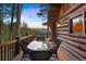 Outdoor dining on deck with mountain views. Enjoy peaceful evenings in this serene outdoor space at 4560 Hilltop Rd, Evergreen, CO 80439