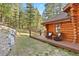 Cozy deck space with rocking chairs, offering a serene view of the surrounding landscape and beautiful log home at 4560 Hilltop Rd, Evergreen, CO 80439