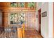 The entryway features stained glass windows, terra cotta floors, and natural wood accents at 4560 Hilltop Rd, Evergreen, CO 80439