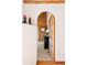 Hallway with an arched doorway leading into a log cabin interior at 4560 Hilltop Rd, Evergreen, CO 80439