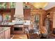 Log-cabin kitchen featuring wooden cabinets, stainless steel range, and dining table at 4560 Hilltop Rd, Evergreen, CO 80439