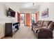 Cozy living room featuring a comfortable couch and media center with views into adjacent rooms at 4560 Hilltop Rd, Evergreen, CO 80439