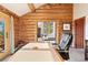 Log-cabin office with a view of a bedroom through the doorway at 4560 Hilltop Rd, Evergreen, CO 80439