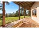 Stone patio with wooden bench and mountain views surrounded by mature trees at 4560 Hilltop Rd, Evergreen, CO 80439