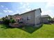 Well-maintained fenced backyard featuring a lush lawn, patio, mature trees and tasteful landscaping at 9046 Sandpiper Dr, Frederick, CO 80504