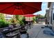 Outdoor patio with tasteful furniture, a grill, a fire pit, and a red umbrella for cozy outdoor living at 9046 Sandpiper Dr, Frederick, CO 80504