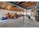 Unfinished basement space featuring concrete floors, support beams, and natural light from multiple windows at 9046 Sandpiper Dr, Frederick, CO 80504