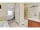 Bathroom with dual access showcasing walk-in shower, dual sinks, and vanity at 9046 Sandpiper Dr, Frederick, CO 80504