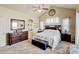 Primary bedroom with neutral colors, carpeted floors, bench at the end of the bed, and attached bath at 9046 Sandpiper Dr, Frederick, CO 80504