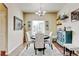Formal dining room with a round table, decorative rug, chandelier, and ample natural light at 9046 Sandpiper Dr, Frederick, CO 80504
