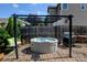 Cozy backyard hot tub area with pergola, grill, and comfortable seating for relaxation at 9046 Sandpiper Dr, Frederick, CO 80504