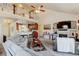 Open-concept living room featuring a fireplace, vaulted ceiling, and kitchen view at 9046 Sandpiper Dr, Frederick, CO 80504
