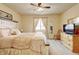 A comfortable bedroom with a large bed, a dresser, and a window with bright, natural light at 9046 Sandpiper Dr, Frederick, CO 80504