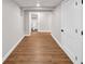 Finished basement area showcasing hardwood floors, white walls, with a view of a full bathroom at 1300 Cherry St, Denver, CO 80220