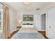 Serene bedroom with hardwood floors, natural light, and minimalist decor featuring framed art and a side table at 1300 Cherry St, Denver, CO 80220