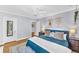 Charming bedroom with hardwood floors, ceiling fan and a stylish decor and a plush blue comforter at 1300 Cherry St, Denver, CO 80220
