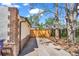 Exterior shot showcasing the side of the house, a gated area, and the surrounding neighborhood at 1300 Cherry St, Denver, CO 80220