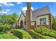 A well-manicured lawn and hedges highlight the brick and stucco exterior of this inviting home at 1300 Cherry St, Denver, CO 80220