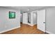 Spacious hallway with hardwood floors, white trim, and multiple doorways creating seamless transitions at 1300 Cherry St, Denver, CO 80220