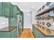 Stylish kitchen features green cabinets, stainless steel appliances, and lots of storage at 1300 Cherry St, Denver, CO 80220