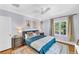 Calming main bedroom with a ceiling fan, area rug, and natural light from a large window at 1300 Cherry St, Denver, CO 80220