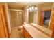 Bathroom with a glass shower, double sinks, tile countertops, and neutral-colored walls at 7076 Boreas Rd, Larkspur, CO 80118