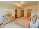 A lovely bedroom featuring neutral paint, carpet, with a vanity area and access to an attached bath at 7076 Boreas Rd, Larkspur, CO 80118
