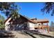 Exterior of home featuring a 3-car garage, stone accents, and back deck, set on a green lot at 7076 Boreas Rd, Larkspur, CO 80118