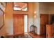 Inviting foyer features hardwood floors, wood doors, and decorative lighting and rug at 7076 Boreas Rd, Larkspur, CO 80118