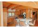 Open concept kitchen with wood beam ceilings, a center island, and custom cabinetry at 7076 Boreas Rd, Larkspur, CO 80118
