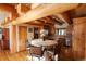 Kitchen featuring wood beam ceilings, a center island with seating, and stainless steel appliances at 7076 Boreas Rd, Larkspur, CO 80118