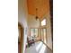 Bright and airy living room with wood ceiling, large windows, and access to a deck at 7076 Boreas Rd, Larkspur, CO 80118