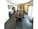 Open concept kitchen and dining area with modern cabinetry and island, adjacent to sliding glass door at 7435 E 159Th Pl, Thornton, CO 80602