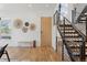 Inviting foyer with modern decor, wood floors, and striking staircase with metal railings at 1801 W 33Rd Ave, Denver, CO 80211