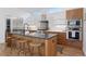 Modern kitchen with stainless steel appliances, island with seating, and custom cabinetry at 1801 W 33Rd Ave, Denver, CO 80211