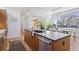 Gourmet kitchen with an island, modern appliances, and an adjacent dining area at 1801 W 33Rd Ave, Denver, CO 80211