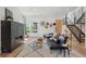 Bright living room with modern fireplace, wood floors, and contemporary furnishings at 1801 W 33Rd Ave, Denver, CO 80211