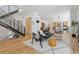 Open-concept living room with hardwood floors, stylish furniture, and a modern staircase at 1801 W 33Rd Ave, Denver, CO 80211