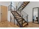 Modern staircase featuring wood steps and metal railings, providing access to upper floors at 1801 W 33Rd Ave, Denver, CO 80211