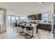 Eat-in kitchen featuring an island with bar seating, stainless appliances, and adjacent dining area at 4114 Estrella St, Brighton, CO 80601