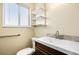 Bathroom boasts modern faucet, stylish backsplash, shelves, and accessible handrail at 726 Mobile St, Aurora, CO 80011