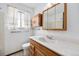 Bathroom featuring vanity and sink with built in cabinets and window at 726 Mobile St, Aurora, CO 80011