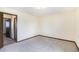 Empty bedroom with neutral walls, trim, and carpet with connecting door at 726 Mobile St, Aurora, CO 80011