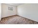 Bedroom features a window and dated carpet at 726 Mobile St, Aurora, CO 80011