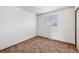 Bedroom with dated carpet and window at 726 Mobile St, Aurora, CO 80011