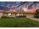 Charming single-story home with well-manicured lawn and mature trees under a colorful sunset at 726 Mobile St, Aurora, CO 80011
