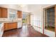 Cozy kitchen with wood cabinets, laminate countertops, and sliding glass doors to the backyard at 726 Mobile St, Aurora, CO 80011