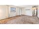 Bright living room featuring a large window, vintage carpet, and neutral wall colors at 726 Mobile St, Aurora, CO 80011
