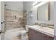 Updated bathroom features modern vanity, fixtures and tiled shower and tub at 9679 W Chatfield Ave # C, Littleton, CO 80128
